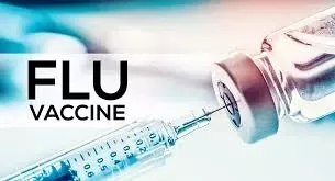 a syringe going into a vial with the words Flu Vaccine